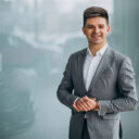 Young handsome business man choosing a car in a car showroom